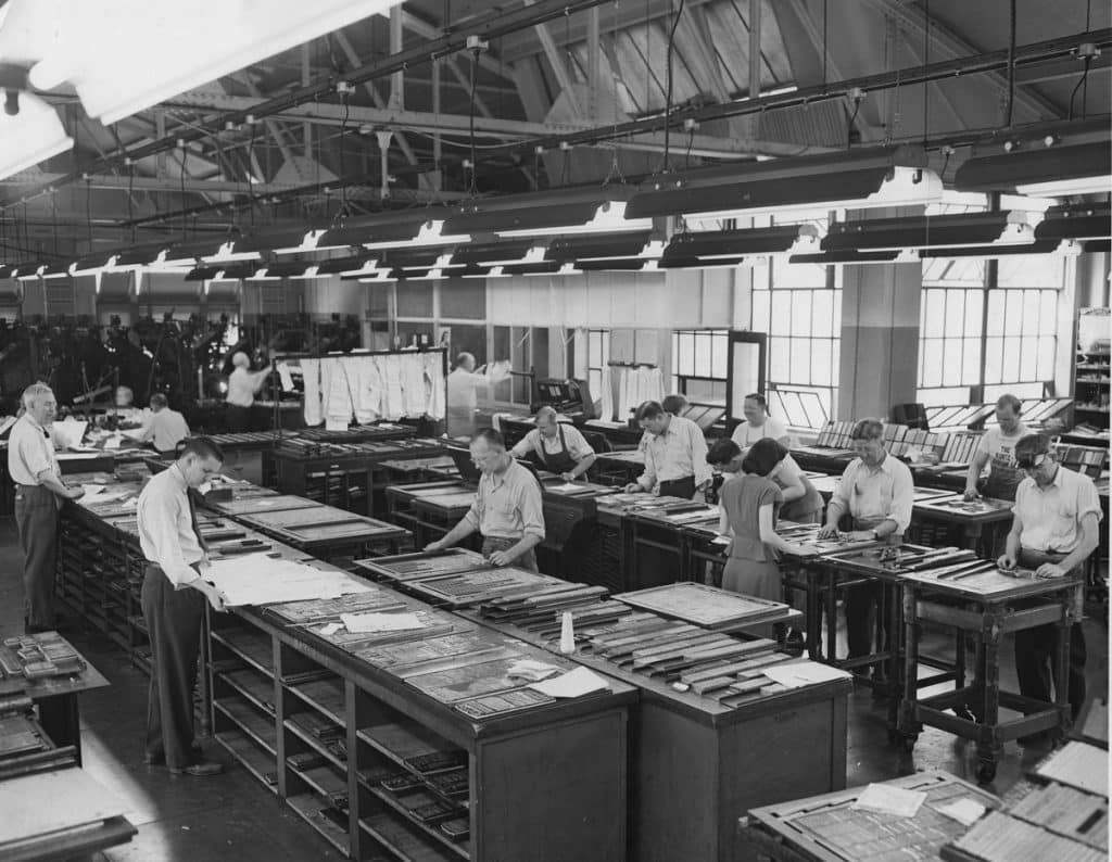 Image of workers printing newspaper in factory